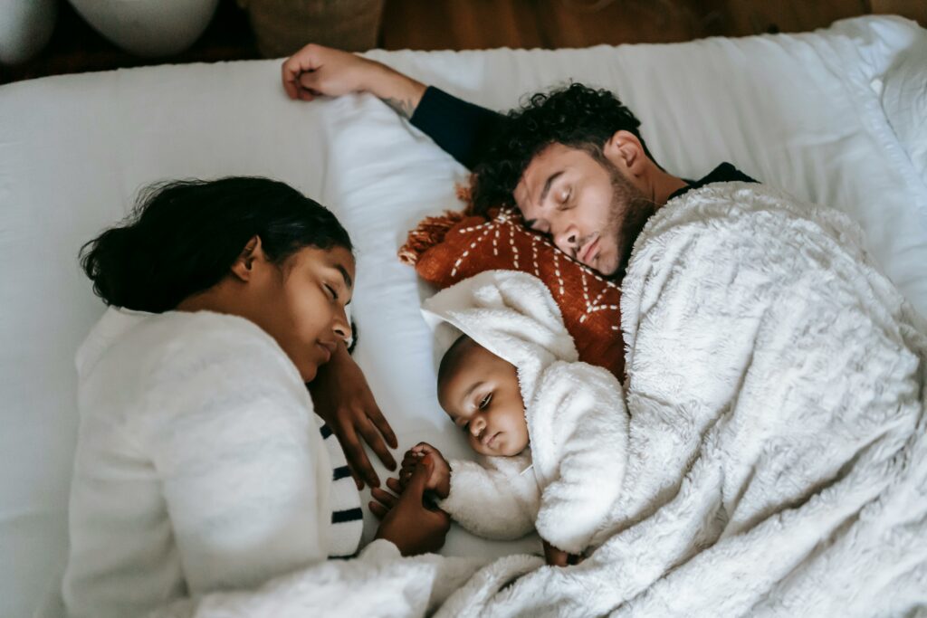 Photo of a family asleep. Photo by William Fortunato, https://www.pexels.com
